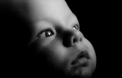 black and white image of baby face in wonder
